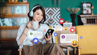 woman on phone looking at social media likes and engagements