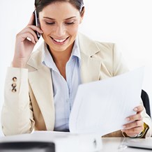 Professional woman on phone | Contract Underwriting